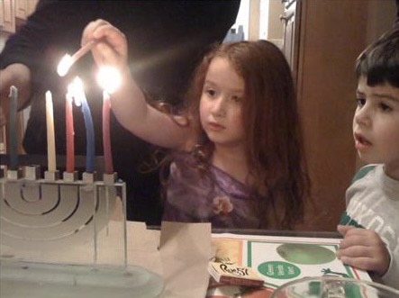 Lior Oren (C24) lights the menorah as a baby.