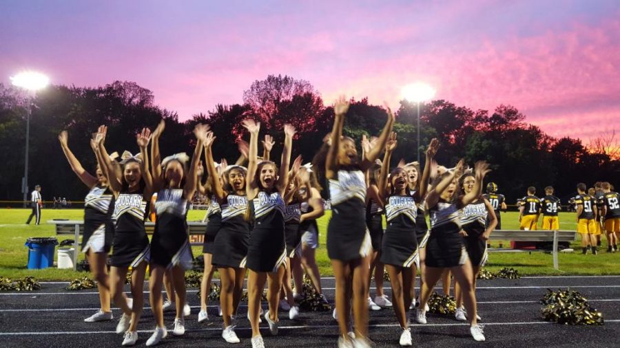 The cheer team addresses an audience of adoring fans.