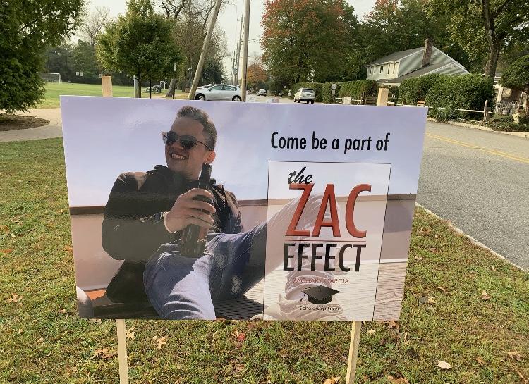 A sign outside the Cresskill 5k, inviting participants to be part of #TheZacEffect