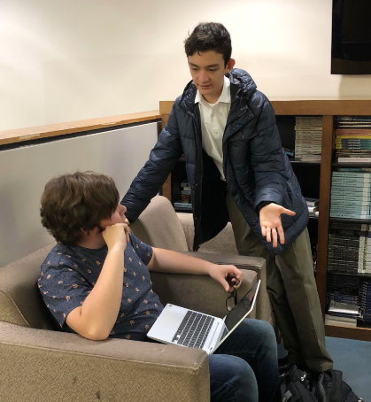 Brendan Huston, sophomore representative for the MUN Club, assists a club member at a position paper workshop on Wednesday.