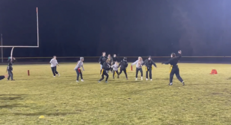 Girls playing football in the 2021 powderpuff game
