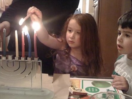 Lior Oren (C'24) lights the menorah as a baby.